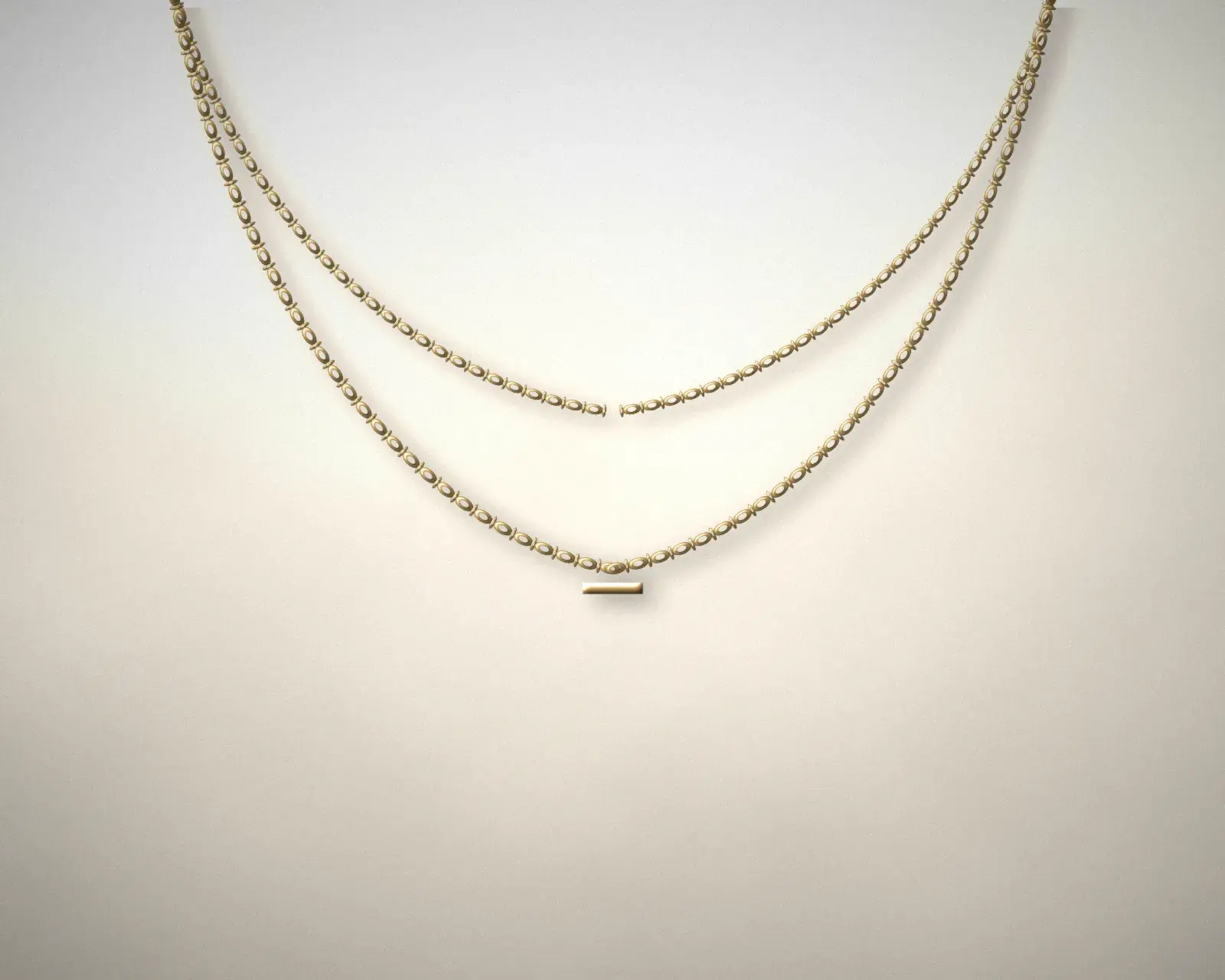 Layered gold-tone necklace on warm limestone
